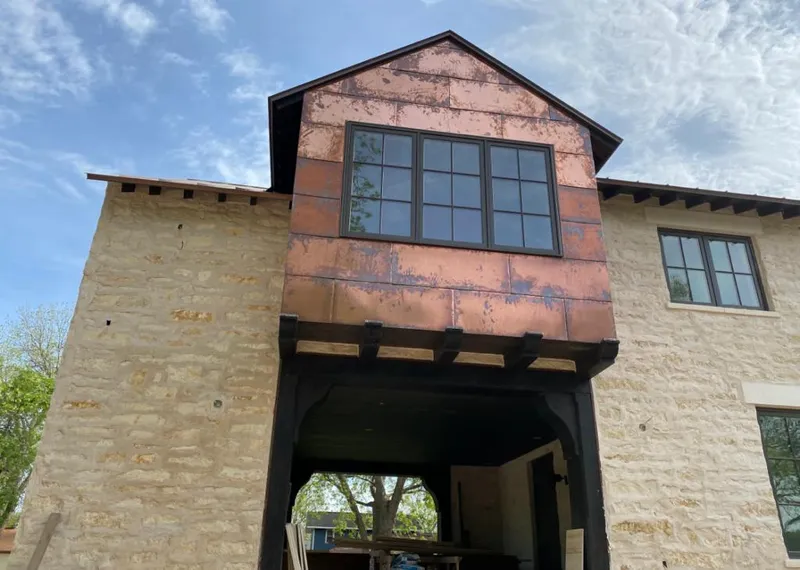 Copper metal panel facade on a stone building for Skylight Installation in Rochester Hills