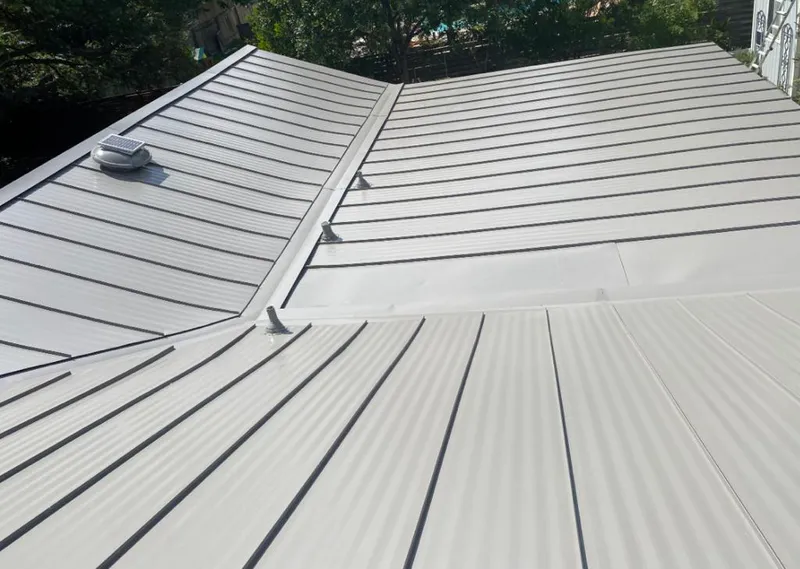 Solar attic fan installed on a metal roof for Roof Ventilation in Rochester Hills